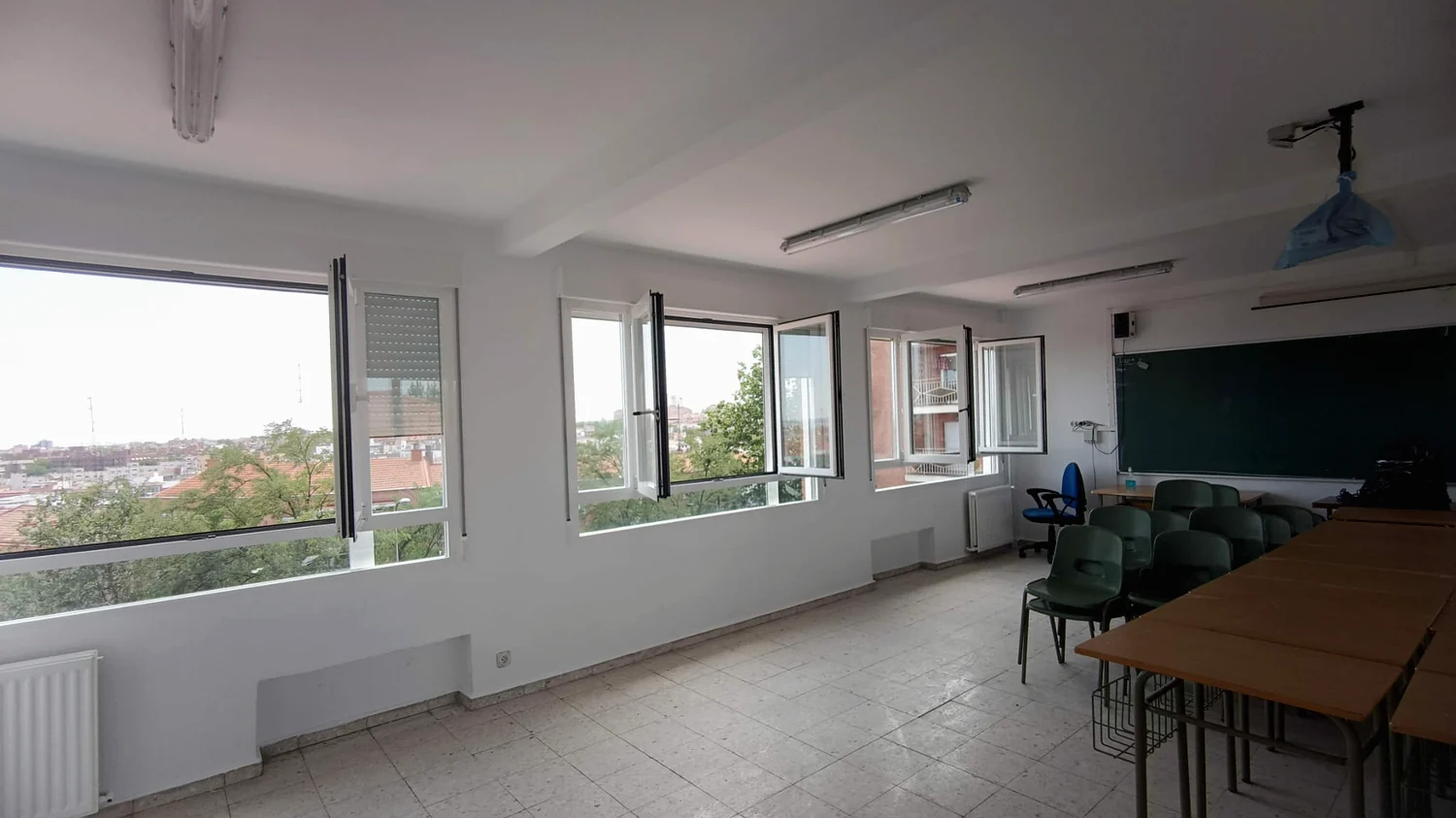 Aula terminada con ventanal y sillas apiladas